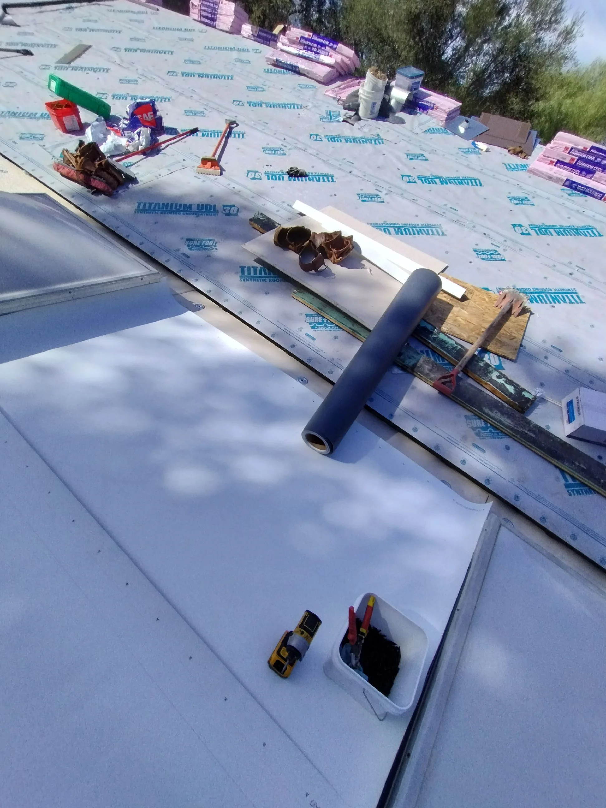 Roof underlayment installation with titanium UDL 50 barrier and drip edge on residential project