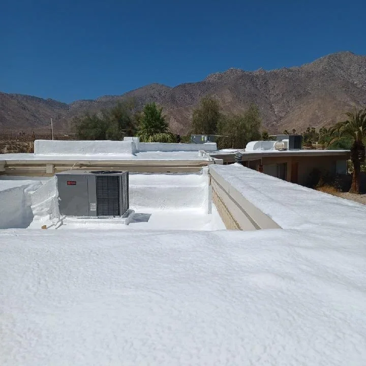 White flat roof with HVAC unit and curbing installation against desert mountain backdrop